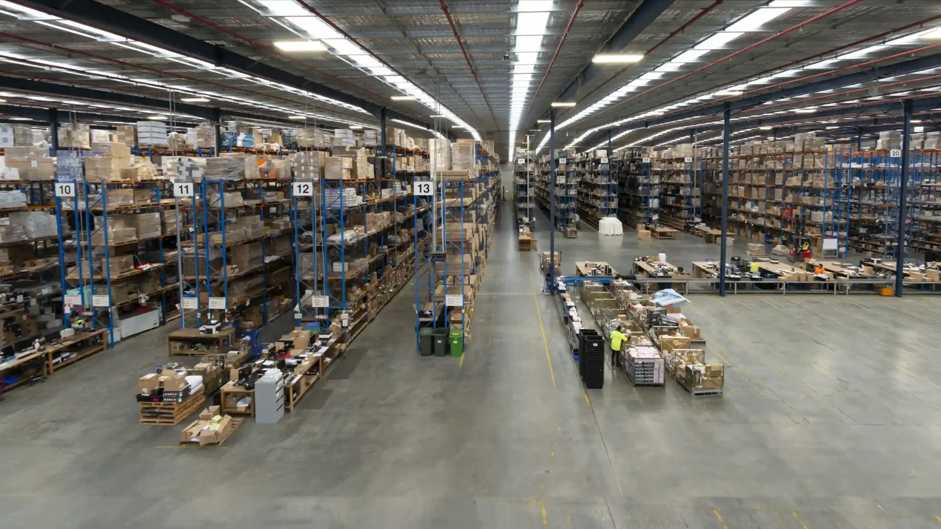 Long perspective view down a wide warehouse aisle with pallet racking in the Minto warehouse.